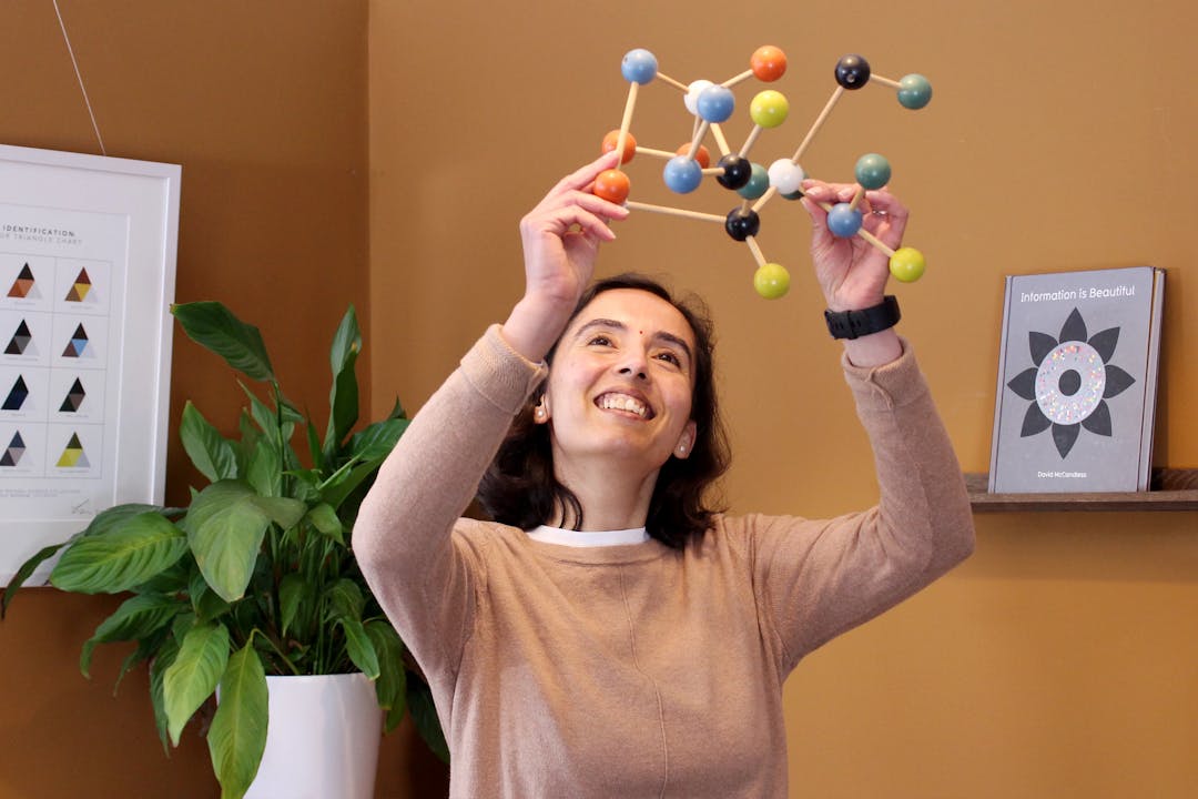 Digital designer Kirti holds wooden structure with coloured balls connected by sticks