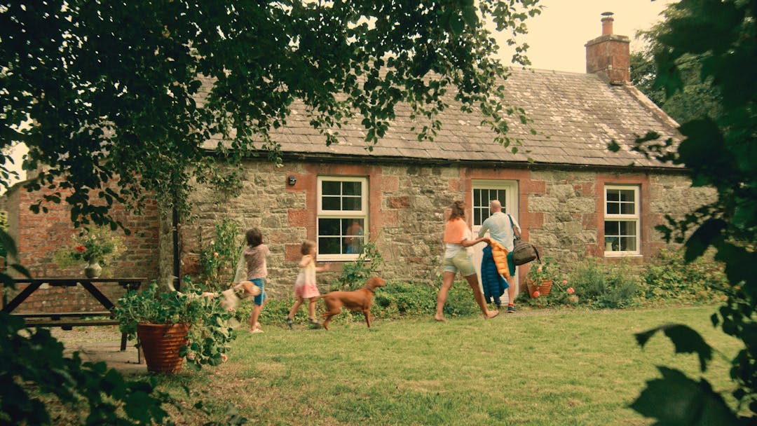 family entering holiday cottage in scotland