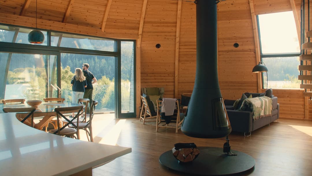 couple looking from balcony in holiday cottage in scotland