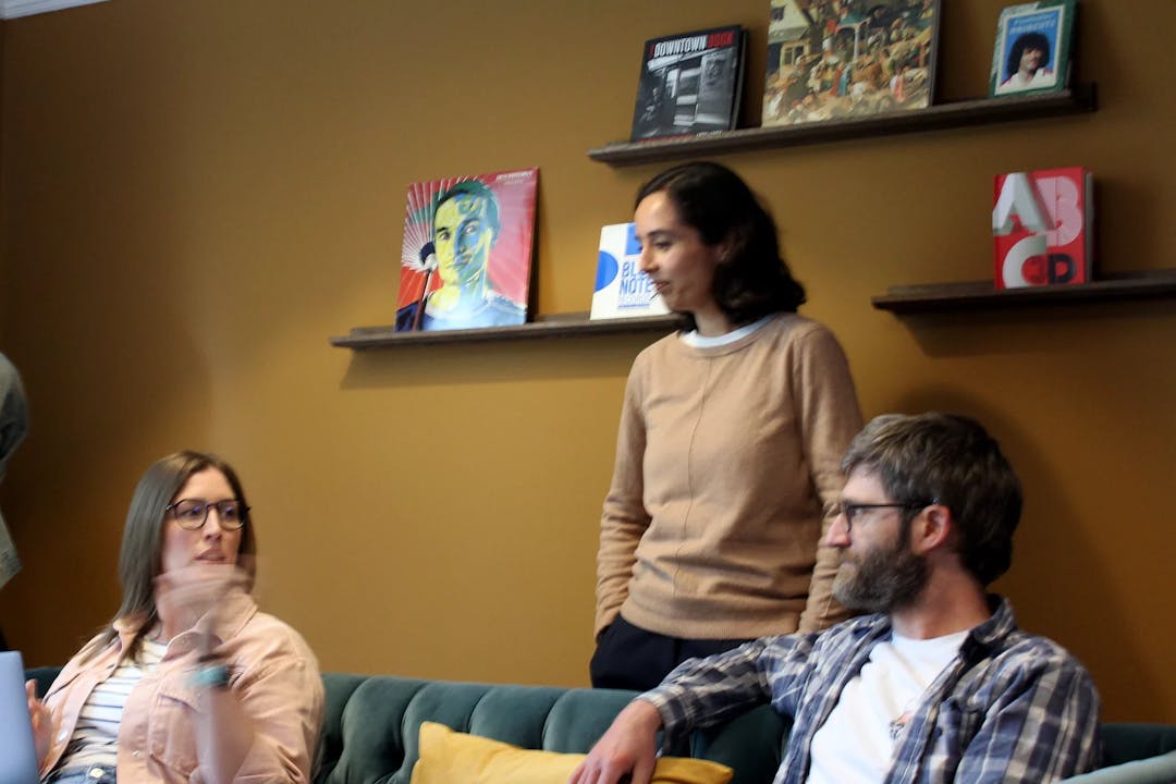 Project manager Katy, Digital Designer Kirti and Developer Mike sat in Bulb Studios lounge discussing upcoming project
