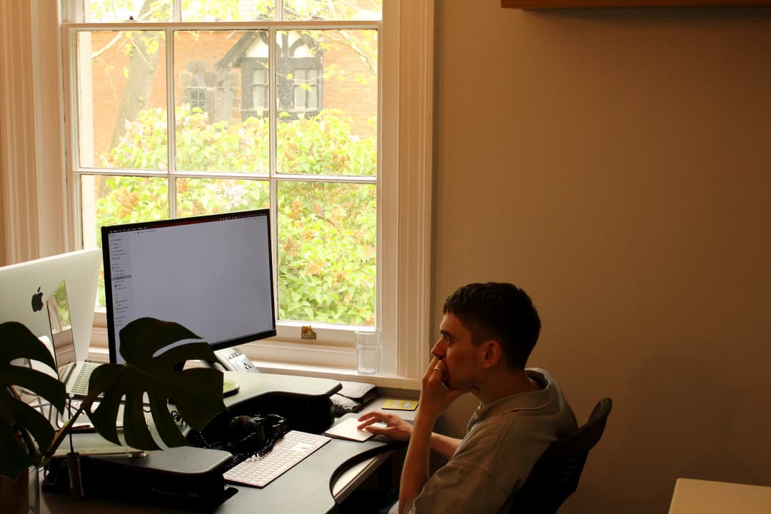 Digital Engagement Manager Dom sat at desk using trackpad whilst working